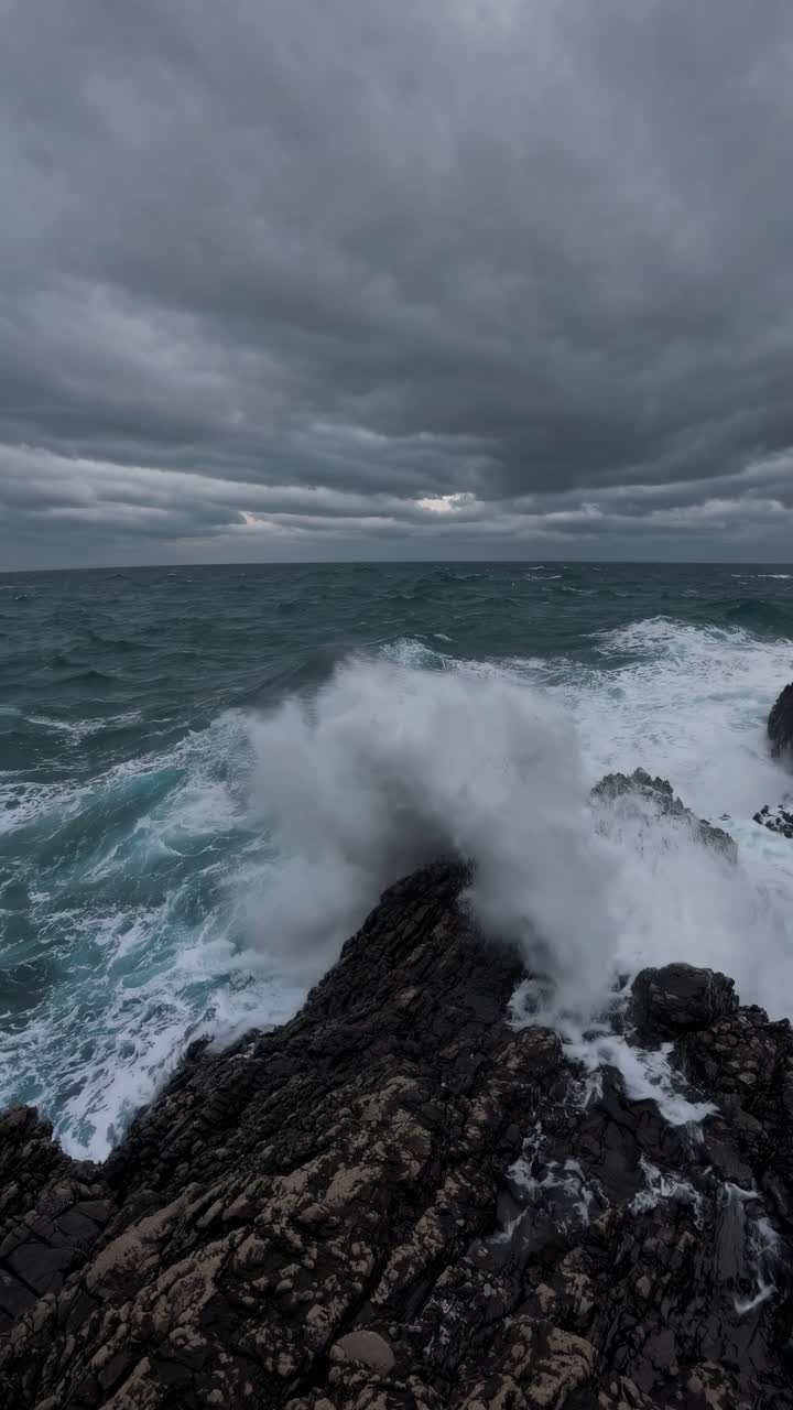 Dramatic seascape video concept with crashing waves on rocky shore