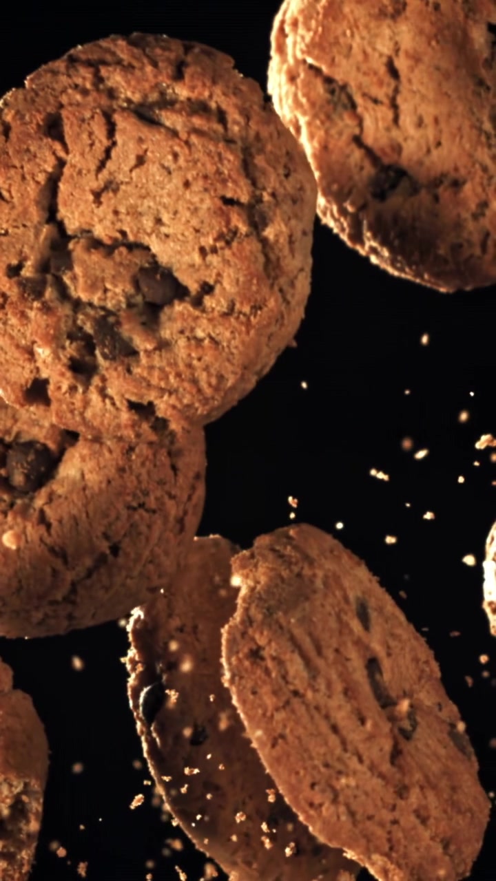 Chocolate Chip Cookies Falling in Slow Motion on Black Background