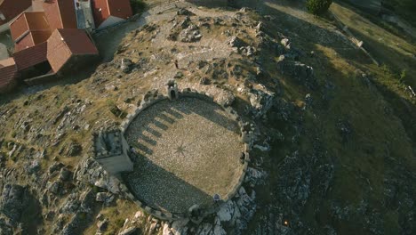 drone flies over the castle of folgosinho and brown bricks tiles of the roofs