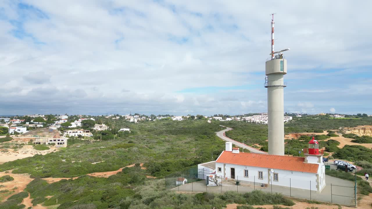 A scenic aerial shot of the Ferragudo Lighthouse, Algarve, with a coastal view