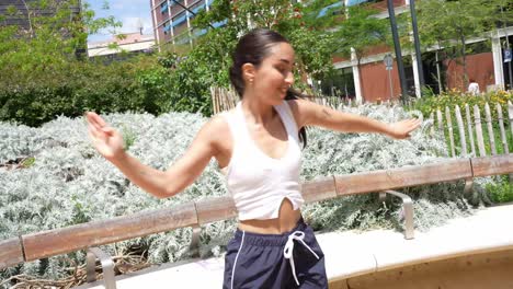 woman dancing outdoors in urban park