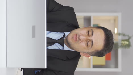 Vertical-video-of-Home-office-worker-man-getting-depressed.