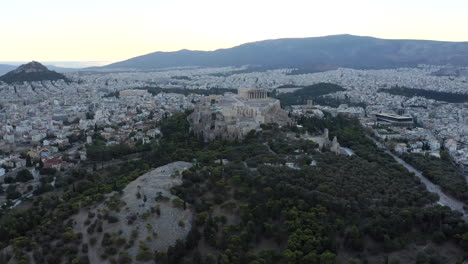 drone aerial shot flying towards acropolis, ancient city of athens, from above in ear morning light, sunrise, greece