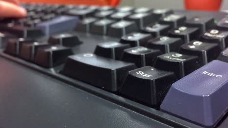 the hands of a person typing on a computer keyboard