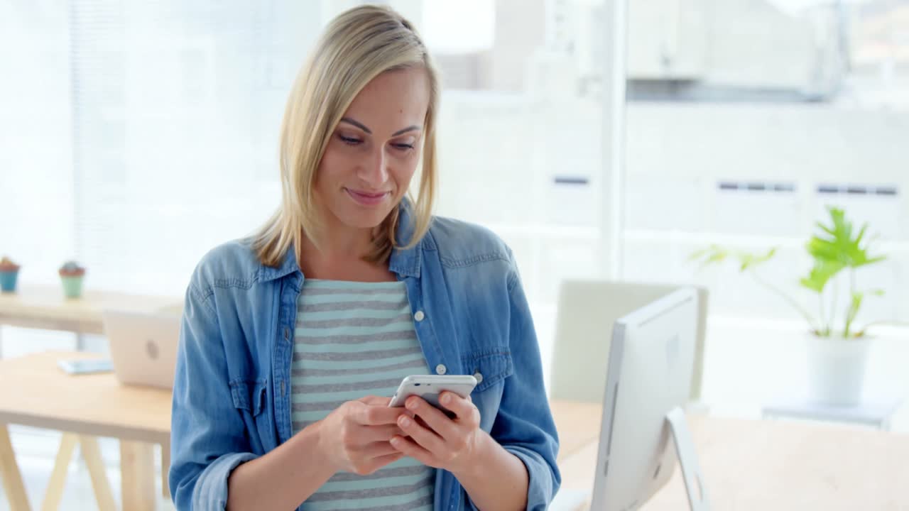 Businesswoman text messaging on mobile phone