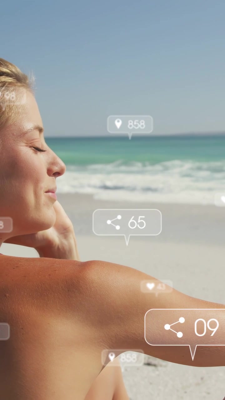 Video verticale: Donna che si ripara gli occhi in spiaggia, con HUD sui "mi piace" che mostrano conteggi in movimento intorno al braccio per i marketer.