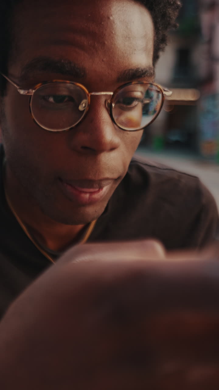 Close-up of Young African American Man Drinking and Looking Down