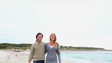 happy couple walking on the beach