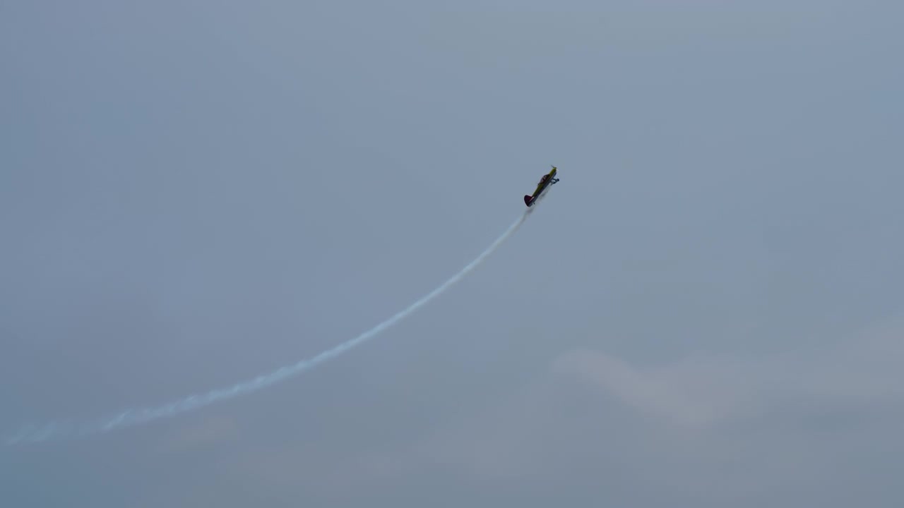 Avião de acrobacias subindo verticalmente com fumaça
