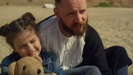 Dad-kid-spending-time-together-on-sandy-beach-sea.-Family-relaxing-on-holiday.