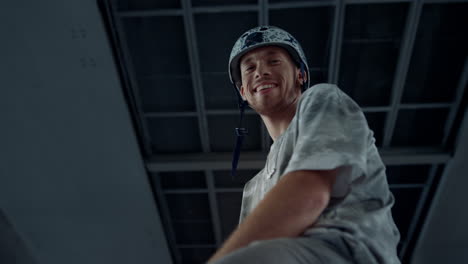 Happy-man-looking-camera-at-urban-skate-park.-Smiling-young-roller-skater.