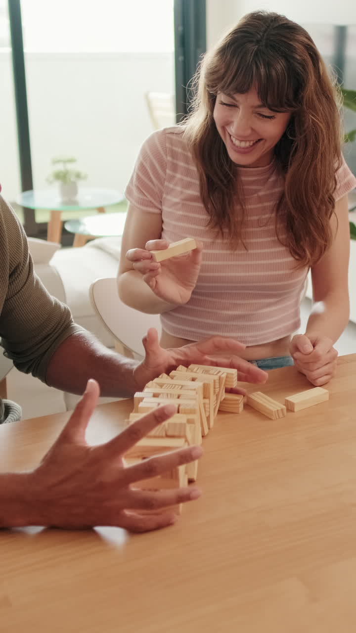 Couple Having Fun Playing Jenga at Home