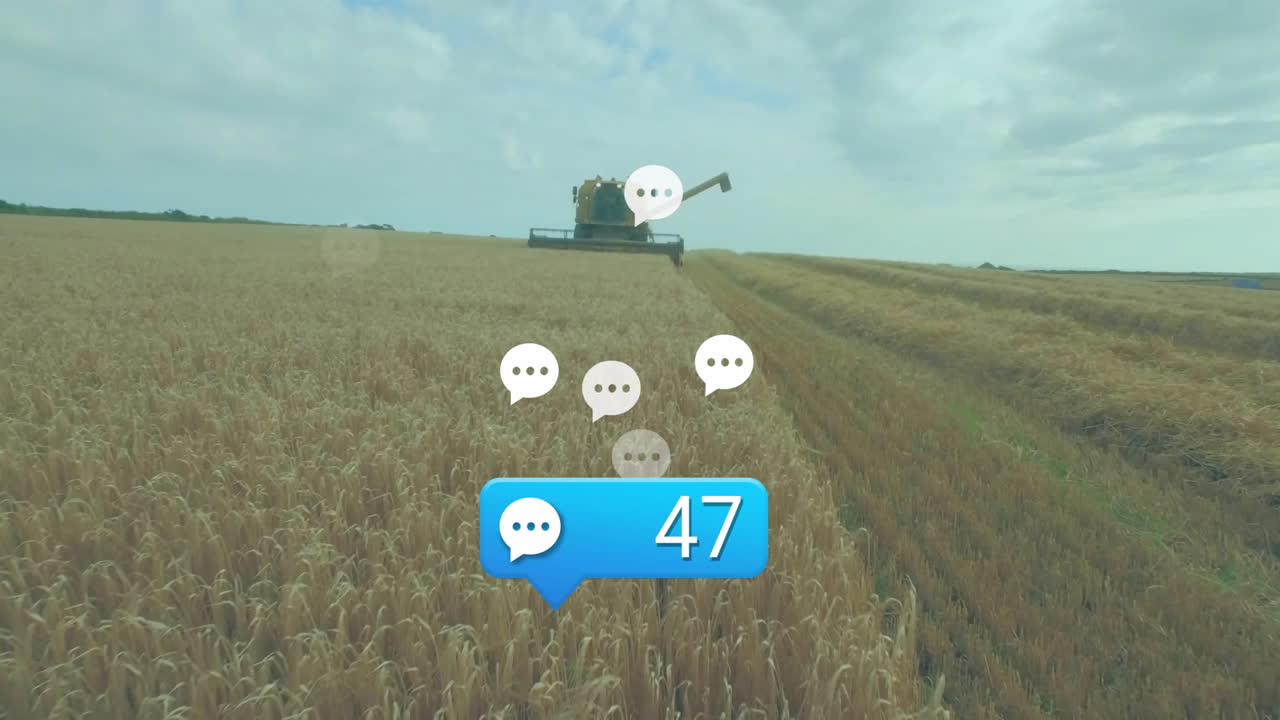 Combine harvester cutting golden wheat field, displaying white chat icons and blue notification 47
