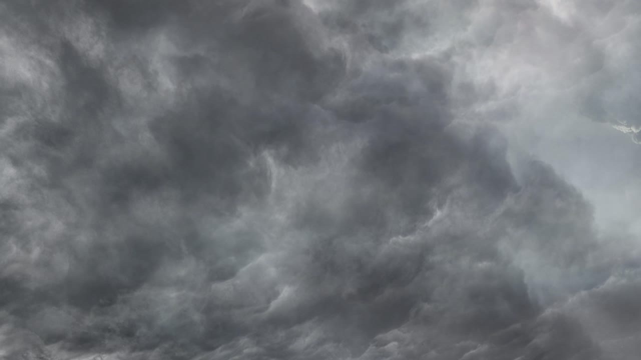 the sky is dark due to thunderstorms in the clouds