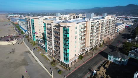 4k aerial drone shot floating away from hotel at seaside, oregon beach