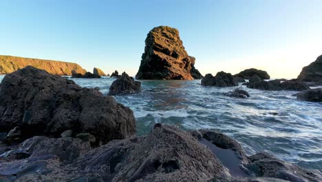 timelapse sea stack and rocks blue waters at golden hour ballydwane beach copper coast waterford ireland