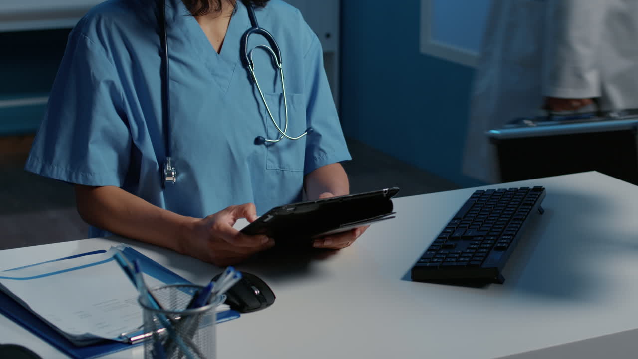 Nurse using tablet at desk