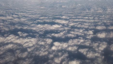 looking out of plane window onto a cloud cover