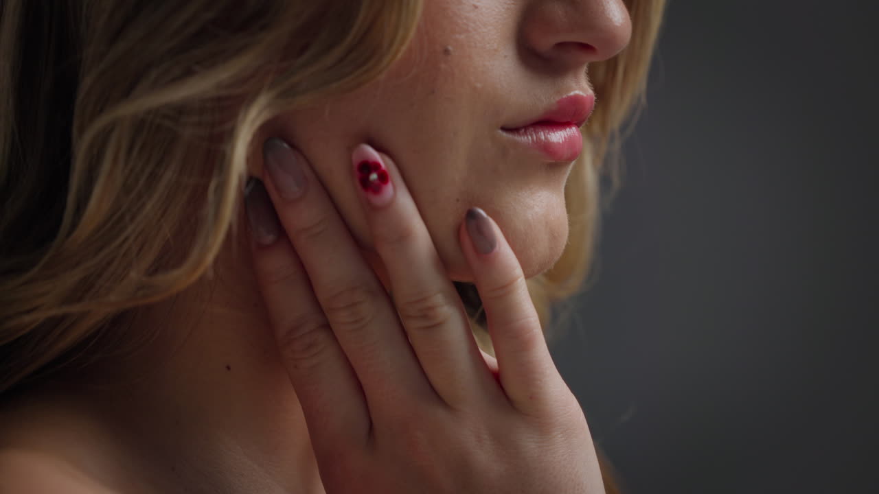 Close-up portrait of a woman with nail art