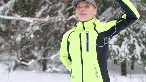 Woman-stretching-her-hands-in-winter-forest