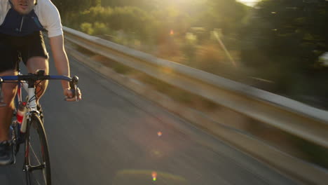 close-up-man-cycling-road-bicycle-outdoors-fitness-steadicam-shot