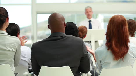 business people listening to a speaker