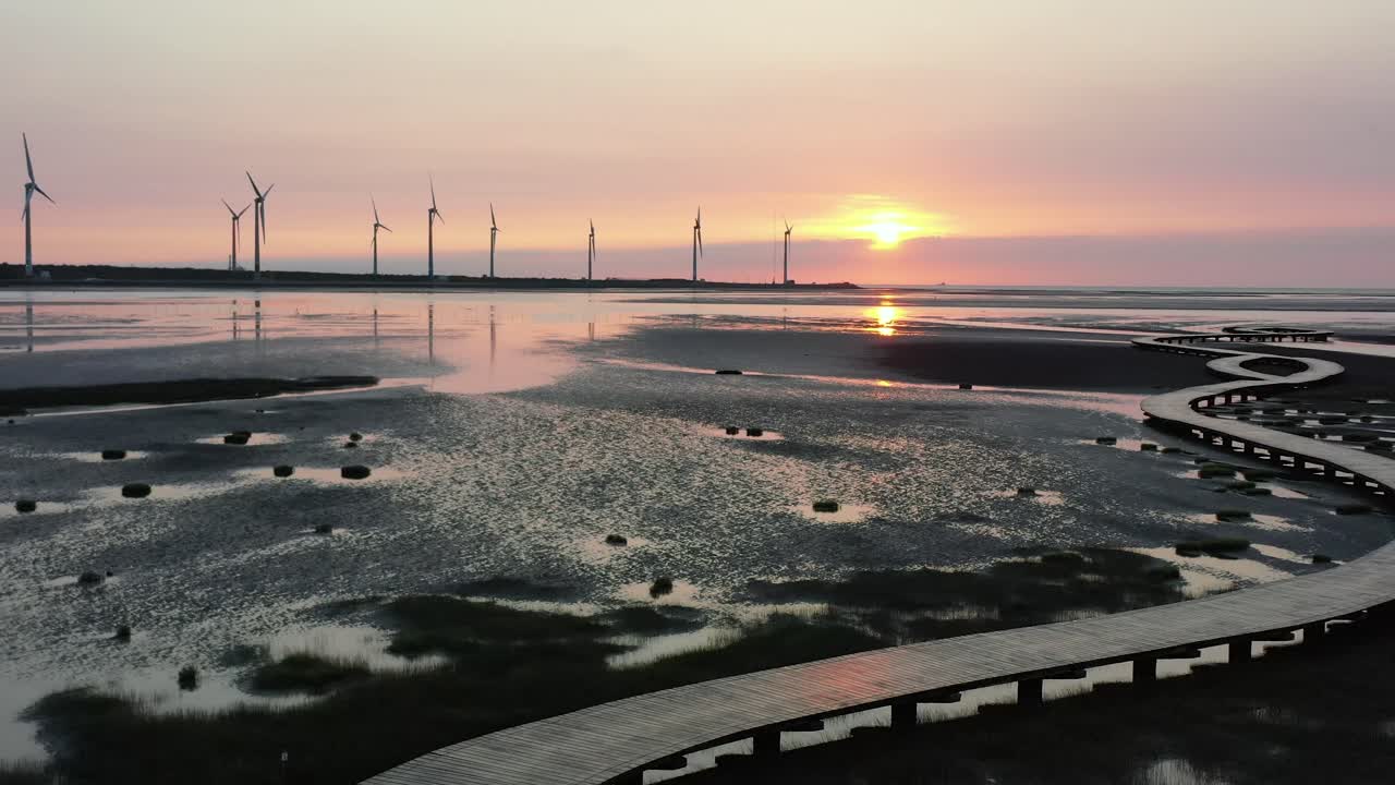 Stunning Sunset over Tidal Flats with Wind Turbines and Wooden Walkway