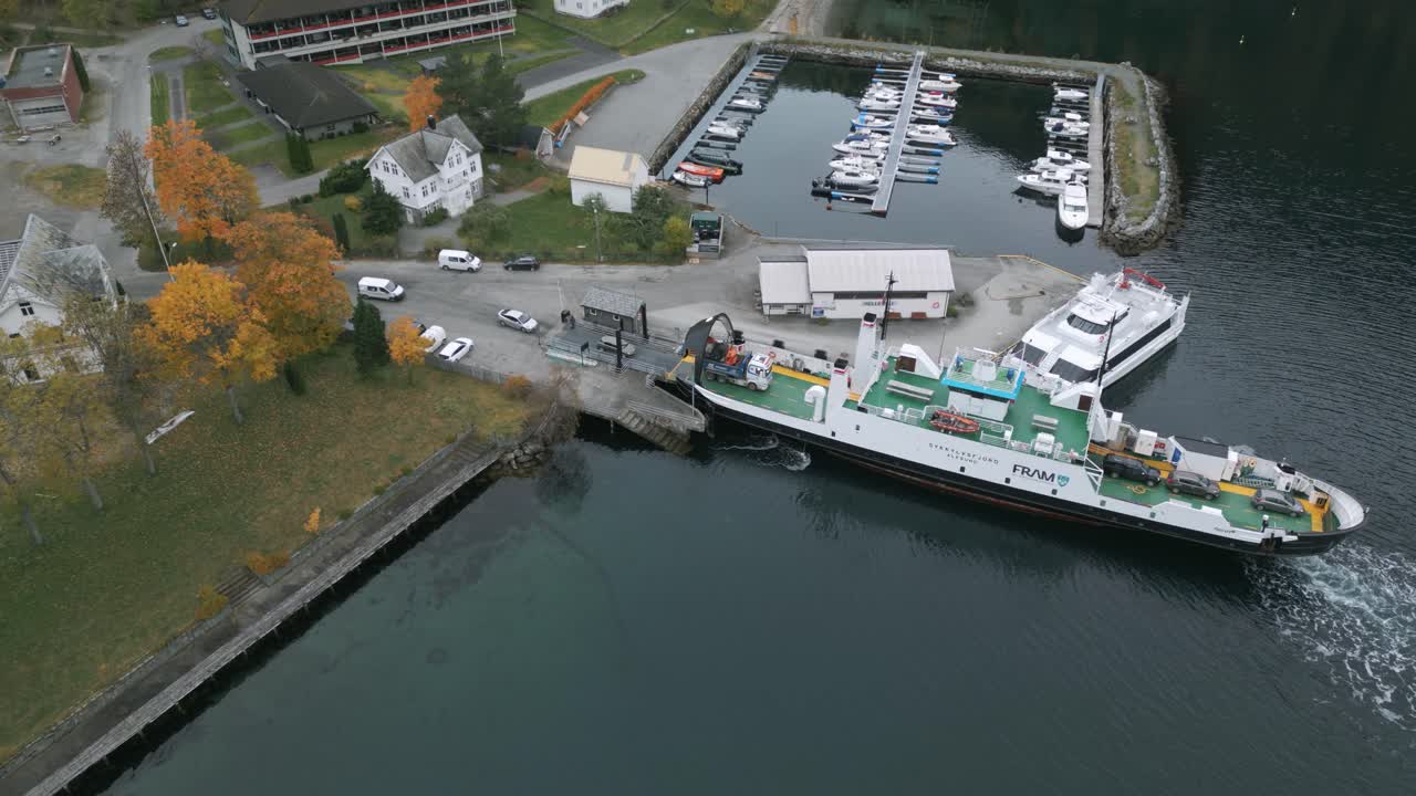 Cars and trucks drive onto the ferry to Geiranger at the harbour of Hellesylt, Norway