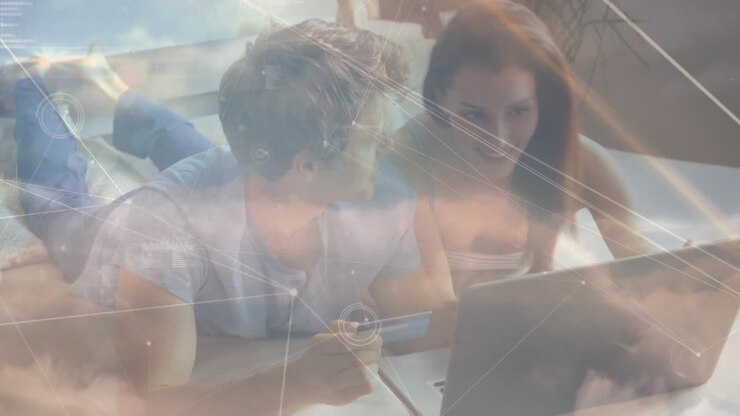 Animation of network of connections over couple paying online using laptop