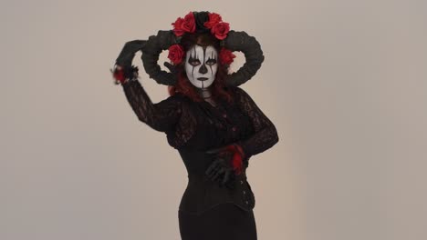 woman in a dark fantasy costume with horns and red roses