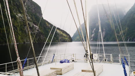 top deck view of sailboat while sailing in majestic fjords, new zealand