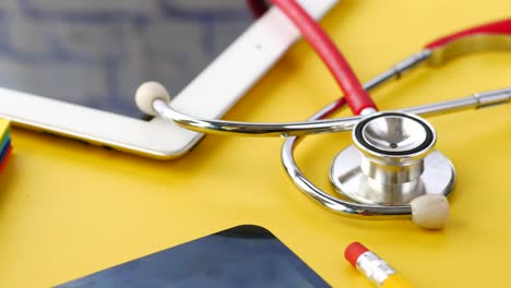 medical equipment and tablet on yellow surface