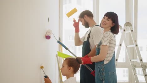 family painting a wall