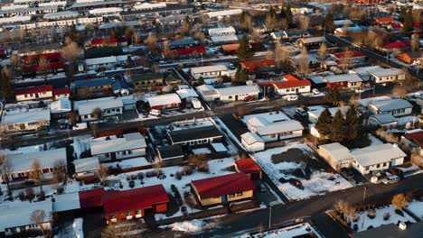 Beautiful-Icelandic-neighborhood-with-multicolored-roofs-at-sunset-in-winter