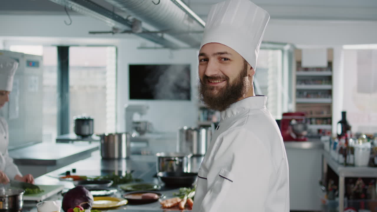 Portrait of man working as cook in gourmet kitchen at restaurant