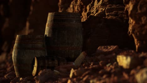 old wooden vintage wine barrels near stone wall in canyon