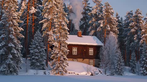 winter cabin in the snowy forest at sunrise