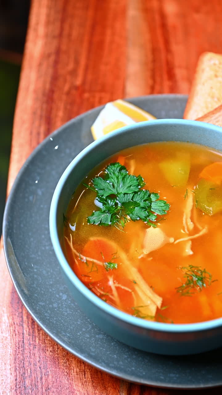 Frisk grøntsagssuppe med kylling. Frisk kyllingesuppe med gulerødder og kartofler serveret varm.