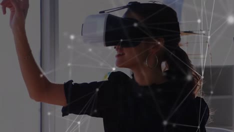 Animation-of-network-of-connections-over-businesswoman-wearing-vr-headsets