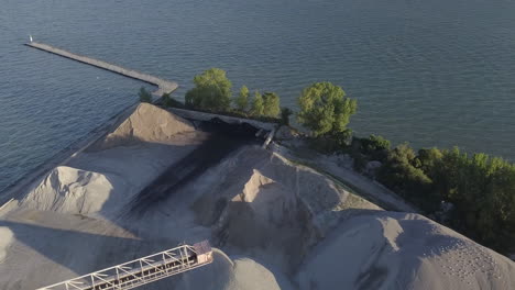 fine sand coming out of the sand dredger at the port in kingsville, ontario, canada - aerial drone