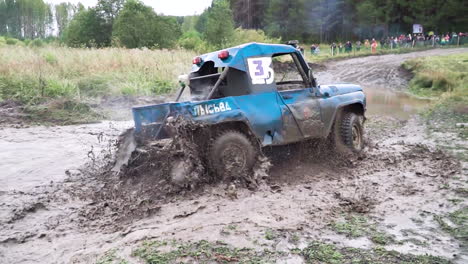 off-road vehicle driving through mud