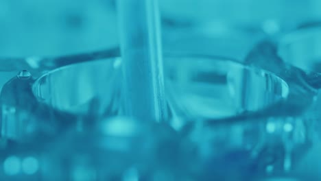 pipette drawing liquid out of microplate well in laboratory