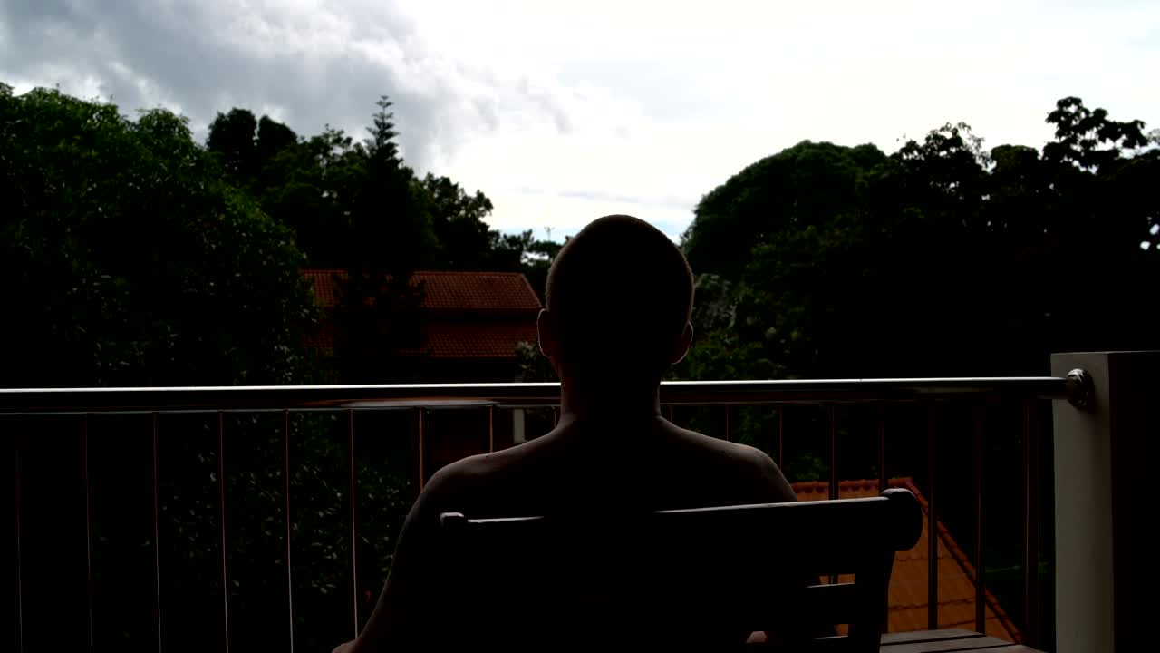 Man sitting on the hotel balcony