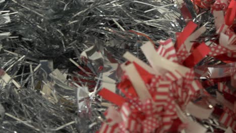 panning right on silver christmas tinsel in a xmas decorations box