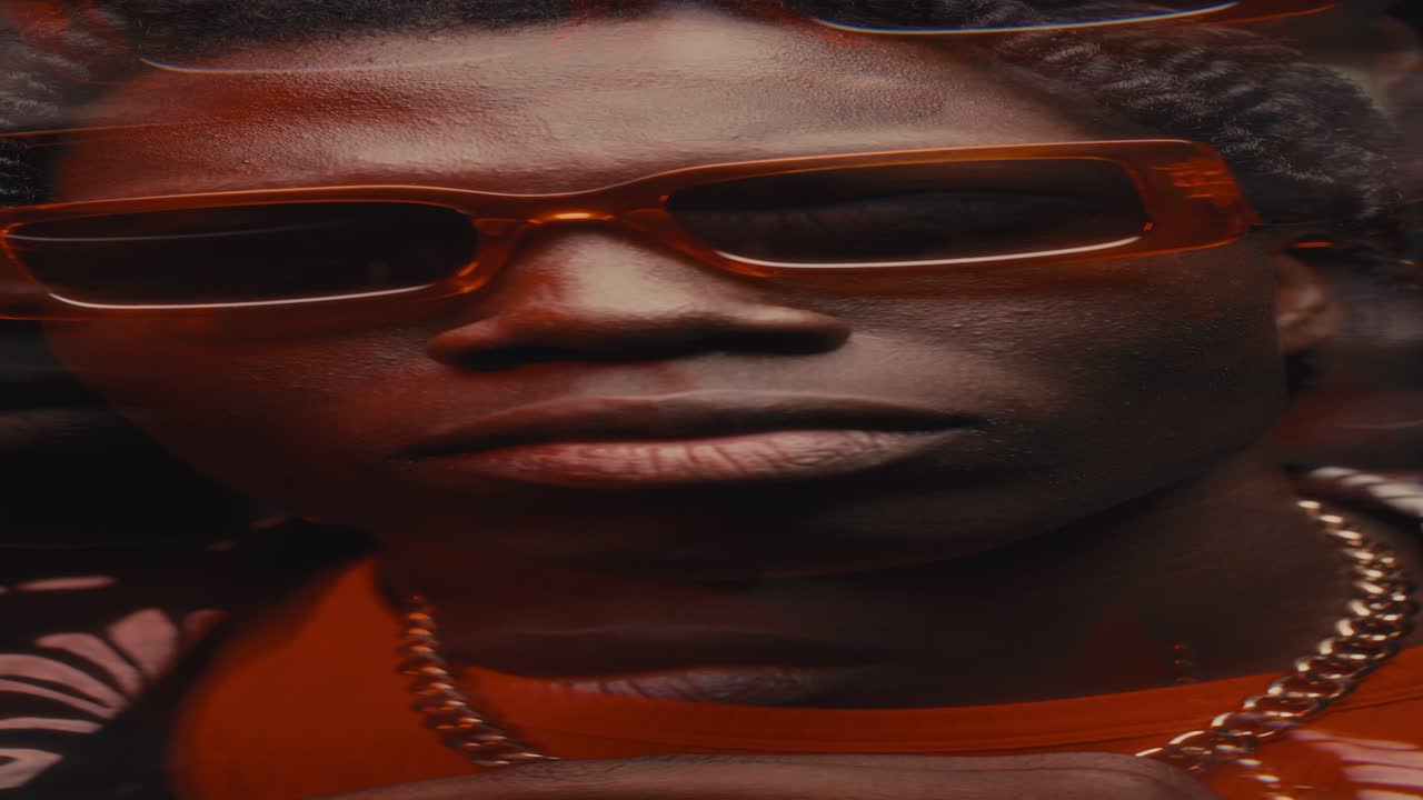 African American Man in Sunglasses Bobbing His Head to Hip-Hop Beat