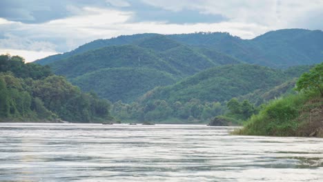 quiet mekong river in the afternoon, scenic nature hill and mountain on background