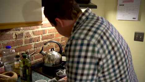 Domesticated-white-male-cleans-the-kitchen-and-stove