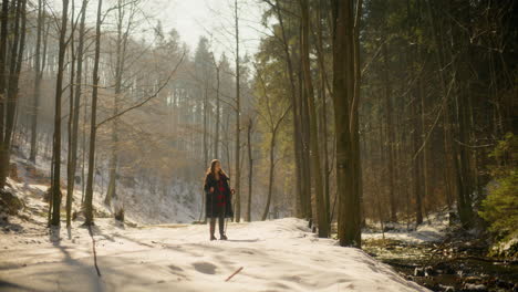 hiker walking by river winter