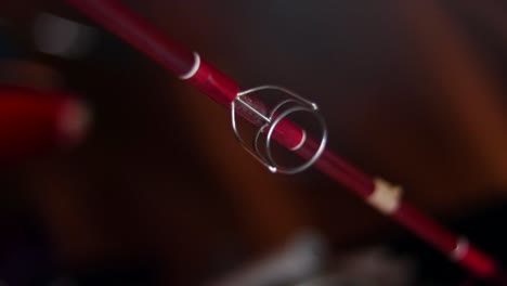 Vintage-red-fishing-rod-in-rafters-of-garage