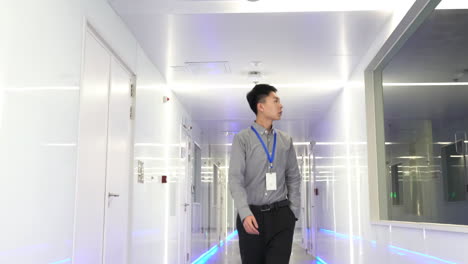 researcher and technician occupational data center, man inspecting servers in a modern facility.
